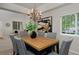 Dining room with wood table, six upholstered chairs, and decorative chandelier at 2500 Lexington St, Lafayette, CO 80026