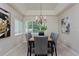 Bright dining room features modern chandelier, tray ceiling, and large windows at 2500 Lexington St, Lafayette, CO 80026