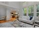 Open living area with hardwood floors, high ceilings, large windows and kitchen view at 2500 Lexington St, Lafayette, CO 80026