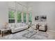 Bright living room with soaring ceilings, large windows and neutral decor at 2500 Lexington St, Lafayette, CO 80026