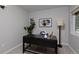 Home office space features a large desk, artwork, and natural light at 2500 Lexington St, Lafayette, CO 80026