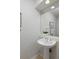 Powder room with pedestal sink, mirror, and neutral color palette at 2500 Lexington St, Lafayette, CO 80026