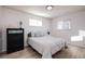 Bright bedroom with a queen bed, dresser, and window coverings at 5986 S Cook St, Littleton, CO 80121