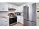 Modern kitchen with stainless steel appliances and white cabinetry at 5986 S Cook St, Littleton, CO 80121