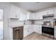 Modern kitchen with white cabinets, stainless steel appliances, and farmhouse sink at 5986 S Cook St, Littleton, CO 80121