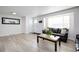 Living room with hardwood floors, featuring a cozy seating area at 5986 S Cook St, Littleton, CO 80121