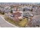 An aerial view of a suburban neighborhood showcasing manicured lawns, mature trees, and well-maintained homes at 7084 Moss Ct, Arvada, CO 80007