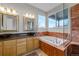 Luxurious bathroom with a soaking tub, double vanity, and a glass-enclosed shower at 7084 Moss Ct, Arvada, CO 80007