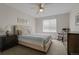 Comfortable bedroom featuring a queen bed, ceiling fan, and natural light from the window at 7084 Moss Ct, Arvada, CO 80007