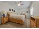 Bright and airy bedroom with a natural wooden bed frame and neutral carpet flooring at 7084 Moss Ct, Arvada, CO 80007