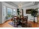 Charming dining room featuring an ornate chandelier, hardwood floors, and a view of the outdoors at 7084 Moss Ct, Arvada, CO 80007