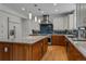 Spacious kitchen with stainless steel appliances, a large island, and a beautiful backsplash at 7084 Moss Ct, Arvada, CO 80007