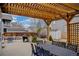 Inviting patio with pergola, outdoor dining set, and grill, perfect for entertaining or enjoying a quiet evening at 7084 Moss Ct, Arvada, CO 80007