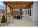 Outdoor patio area with a pergola and a dining set, perfect for outdoor entertaining at 7084 Moss Ct, Arvada, CO 80007