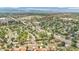 Wide aerial view showcasing a neighborhood with homes, lush greenery, and distant mountains at 8759 Seton St, Westminster, CO 80031