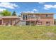 Large backyard showcasing a brick home with a deck and a well-maintained lawn, great for Gathering gatherings at 8759 Seton St, Westminster, CO 80031