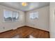 Well-lit bedroom with laminate floors and natural light through two windows at 8759 Seton St, Westminster, CO 80031