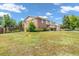 Charming two-story brick home with a well-maintained lawn, garden, and mature trees at 8759 Seton St, Westminster, CO 80031