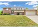 Charming home with a well-kept lawn, brick accents, and an attached two-car garage at 8759 Seton St, Westminster, CO 80031