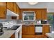Updated kitchen with sleek countertops, wood cabinets, and modern stainless steel appliances at 8759 Seton St, Westminster, CO 80031