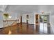 Bright open-concept space with hardwood floors, staircase, and a view into the kitchen at 8759 Seton St, Westminster, CO 80031