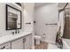 Bright bathroom featuring stylish vanity with black hardware, plus a shower and tub combo at 9019 E Panorama Cir # D218, Englewood, CO 80112