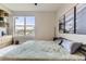 Comfortable bedroom featuring a large window with tree views and stylish decor at 9019 E Panorama Cir # D218, Englewood, CO 80112