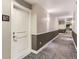 Well-lit hallway with neutral paint, leading to unit 218 at 9019 E Panorama Cir # D218, Englewood, CO 80112