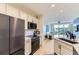 Open-concept kitchen with black appliances, white cabinets, and a clear view into the living area at 9019 E Panorama Cir # D218, Englewood, CO 80112