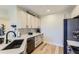 Modern kitchen with sleek white cabinetry, stainless steel appliances, and minimalist design at 9019 E Panorama Cir # D218, Englewood, CO 80112