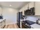 Bright kitchen with black stainless appliances, clean white cabinets and tiled backsplash at 9019 E Panorama Cir # D218, Englewood, CO 80112