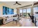 Bright living room with modern furnishings, hardwood floors, and a large balcony overlooking the neighborhood at 9019 E Panorama Cir # D218, Englewood, CO 80112