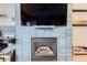 Cozy living room with a tile fireplace and a large screen tv at 9019 E Panorama Cir # D218, Englewood, CO 80112