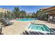 Outdoor pool and hot tub surrounded by lounge chairs and landscaping in a community setting at 9019 E Panorama Cir # D218, Englewood, CO 80112