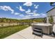Backyard features a modern hot tub, green grass, and mountain views at 15210 W Eastman Ave, Morrison, CO 80465