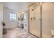 Modern bathroom featuring double sinks, marble flooring, and a glass-enclosed shower at 15210 W Eastman Ave, Morrison, CO 80465
