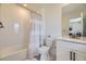 Clean bathroom featuring a shower-tub combo with tile backsplash, toilet, and white vanity at 15210 W Eastman Ave, Morrison, CO 80465