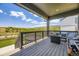 Covered deck with seating, grill, and a beautiful view of the surrounding landscape at 15210 W Eastman Ave, Morrison, CO 80465