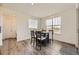Cozy dining area featuring wood floors, ample natural light, and a neutral color palette at 15210 W Eastman Ave, Morrison, CO 80465