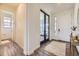 Bright entryway featuring wood floors, neutral walls, black french doors, and a view of the home's interior at 15210 W Eastman Ave, Morrison, CO 80465