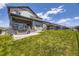 Spacious backyard with large green lawn and stylish two-story home with hot tub at 15210 W Eastman Ave, Morrison, CO 80465