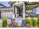 Inviting front porch with stone accents, dark door, and well-maintained landscaping, adding curb appeal at 15210 W Eastman Ave, Morrison, CO 80465