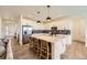 Bright, open kitchen featuring white cabinets, a large island, stainless steel appliances, and modern pendant lighting at 15210 W Eastman Ave, Morrison, CO 80465