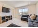 Cozy living room features a large sectional sofa, media center, and bright window views at 15210 W Eastman Ave, Morrison, CO 80465