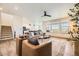 Open-concept living room showcasing stairs, hardwood floors, neutral tones, and an abundance of natural light at 15210 W Eastman Ave, Morrison, CO 80465