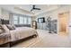 Bright main bedroom with a ceiling fan, TV, and large windows overlooking the landscape at 15210 W Eastman Ave, Morrison, CO 80465