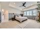 Spacious main bedroom featuring a tray ceiling, plush carpeting, and large windows with natural light at 15210 W Eastman Ave, Morrison, CO 80465