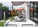 Private backyard featuring a patio with outdoor seating, a shade sail, and manicured landscaping at 2645 Eudora St, Denver, CO 80207
