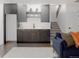 Basement wet bar features modern fixtures, dark cabinets, white countertops and easy access to the stairs at 2645 Eudora St, Denver, CO 80207