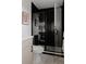 Contemporary bathroom featuring a glass shower, black tile, modern fixtures, and a sleek design at 2645 Eudora St, Denver, CO 80207